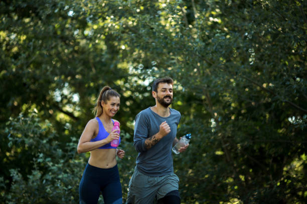 istock Couple jogging, spending time in nature. 1296157262