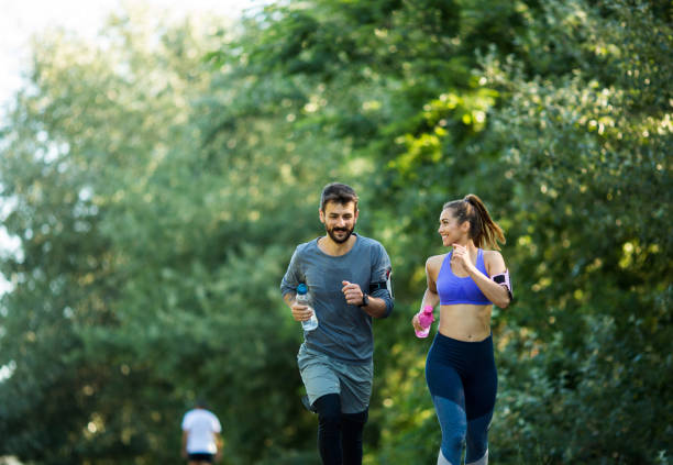istock Young couple jogging on sunny day. 1296157279