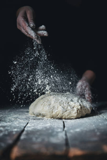istock Kneading Loaf of Bread with Hands 1296157291