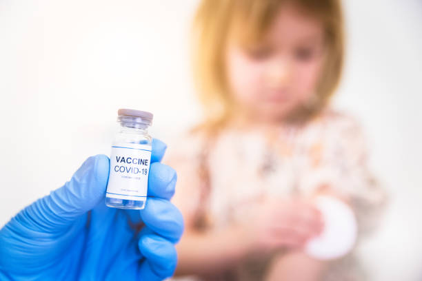 Vaccination of child with anti covid-19 vaccine stock photo