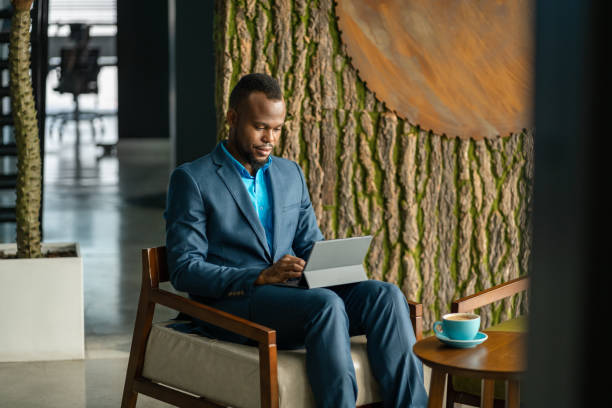 istock Young North African businessman using a tablet in an office lounge 1296157984