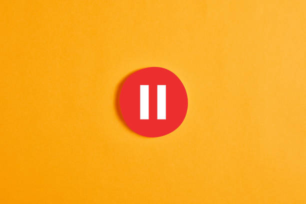 Red round circle with a pause button or icon Red round circle with a pause button or icon against yellow background. break time stock pictures, royalty-free photos & images