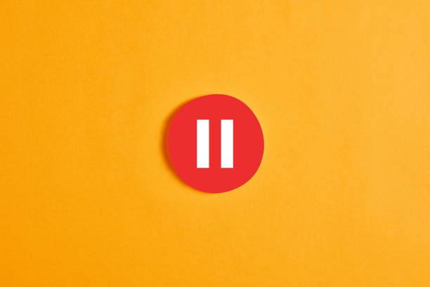 Red round circle with a pause button or icon Red round circle with a pause button or icon against yellow background. taking a break stock pictures, royalty-free photos & images