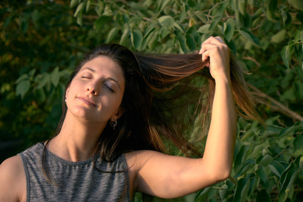 istock model grabbing  her hair  in the woods 1296161249