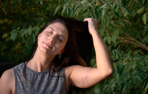 istock model grabbing  her hair  in the woods 1296161986