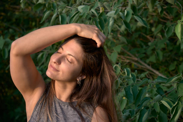 istock model grabbing  her hair  in the woods 1296162065