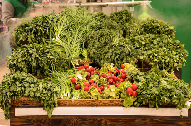 Greenery counter: fresh greens with water sprinkler on farmers market
