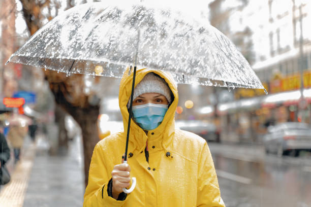 istock Woman with umbrella  on rainy day 1296162589
