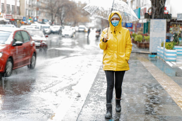 istock Woman with umbrella  on rainy day 1296163105