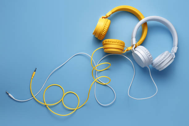 istock Two stylish headphones over blue background. Music concept. 1296163881