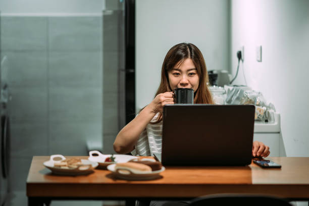 istock Asian chinese young women using laptop and working at home 1296163897