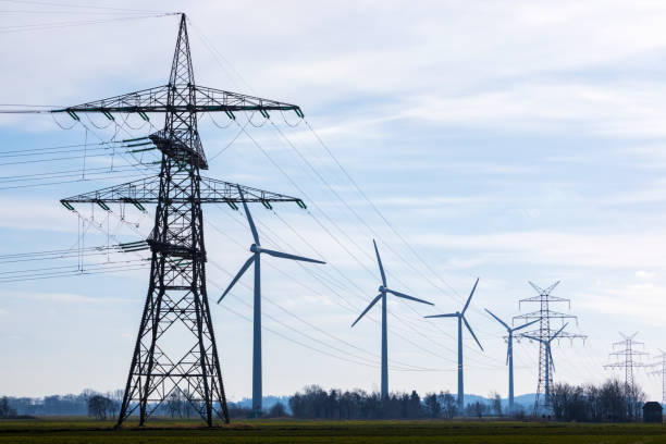 istock Power lines and wind turbines 1296164655