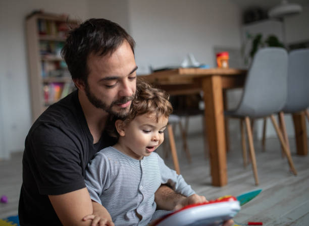 istock Father and son enjoying time together while looking at picture book 1296165079