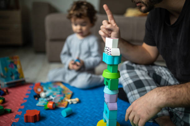 istock Caring dad have fun playing with his son at home 1296165311