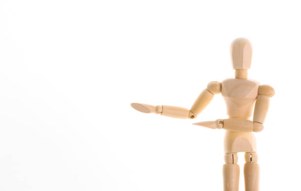 istock Wooden puppet mannequin shows on space for your text isolated on white background. Copy space 1296165334