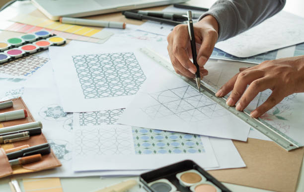 istock Designer designing drawing sketch pattern geometric flower seamless wallpaper fabric textile fashion industry. artistic design studio. 1296166181