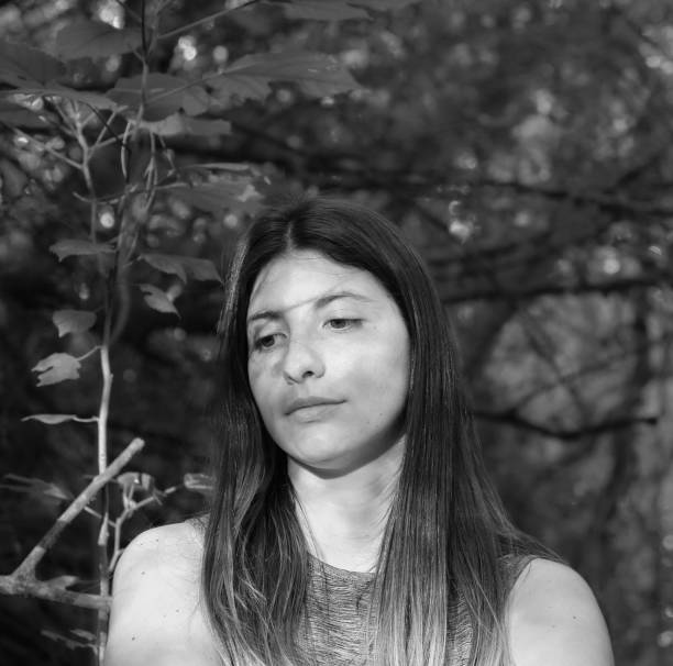 a portrait of a woman model grabbing her hair in the forest