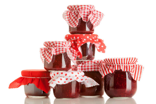 Basket with small jars of homemade fruit jams isolated on white. More pictures...