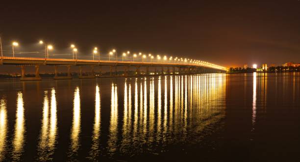 istock Reflection of bright lanterns in the Dnieper river under the bridge 1296167262