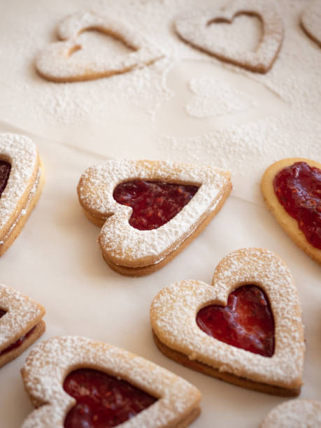 istock Homemade heart shaped cookies with raspberry jam on white background 1296167507