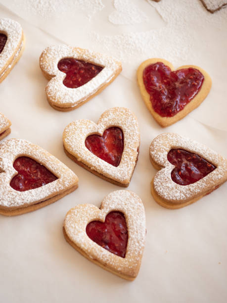 istock Homemade heart shaped cookies with raspberry jam on white background 1296168227