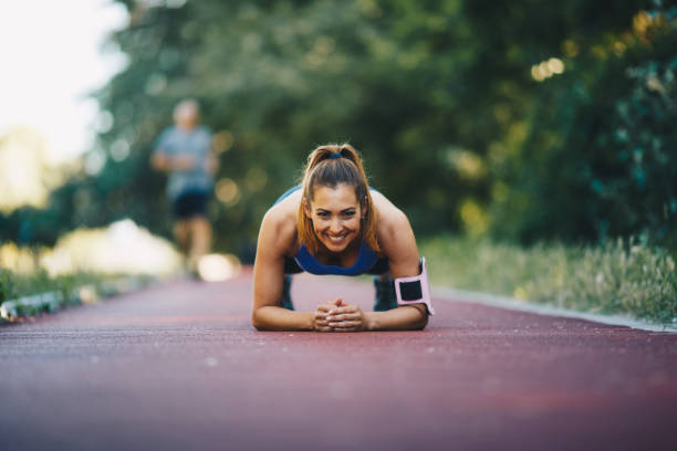 istock young woman is working out, doing planks on treadmill. 1296168265