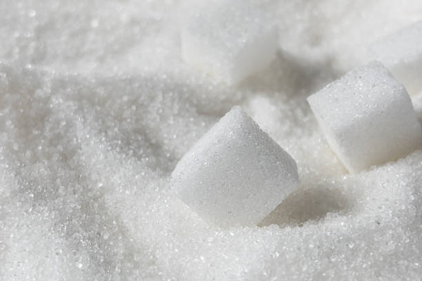 istock White sugar crystals and cubes of refined cane sugar closeup. 1296169319