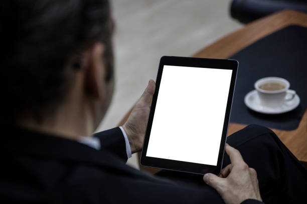 istock Mockup image of businessman holding digital tablet with blank white screen 1296169354