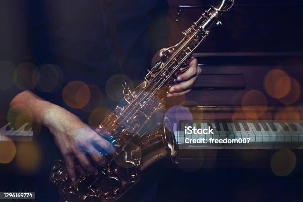 A Musician Plays Alto Saxophone Over The Piano Stock Photo - Download Image Now - Jazz Music, Group Of Objects, Tenor