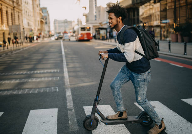 istock Young man ridding electric scooter 1296170574