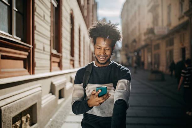 istock Young man ridding electric scooter and using cell phone 1296170649