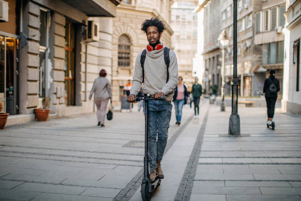 istock Young man ridding electric scooter 1296170759