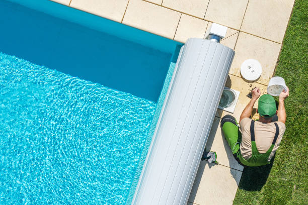 Outdoor Backyard Garden Swimming Pool Maintenance. Caucasian Professional Garden SPA Technician Cleaning Skimmer Filter From Dirt. Outdoor Backyard Garden Swimming Pool Maintenance. swimming pool stock pictures, royalty-free photos & images
