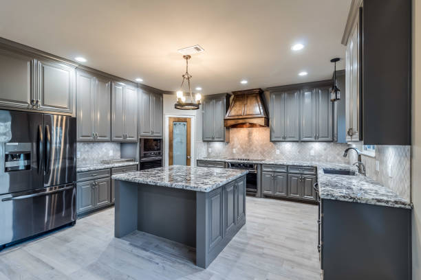 istock Dark grey cabinetry in large enclosed kitchen 1296171084