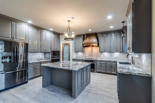 Dark grey cabinetry in large enclosed kitchen Square island with granite countertops inside microwave stock pictures, royalty-free photos & images
