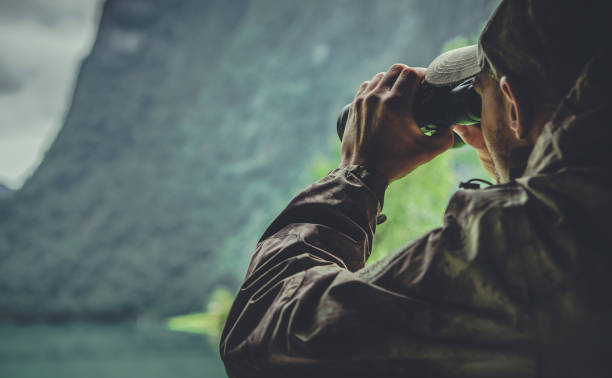 istock Hunter in Camouflage Uniform Spotting Game 1296171911