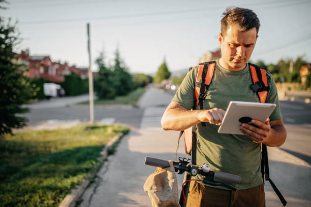 istock Young delivery man on an electric scooter delivering packages 1296172686
