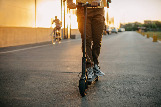 istock Young delivery man on an electric scooter delivering packages 1296173331