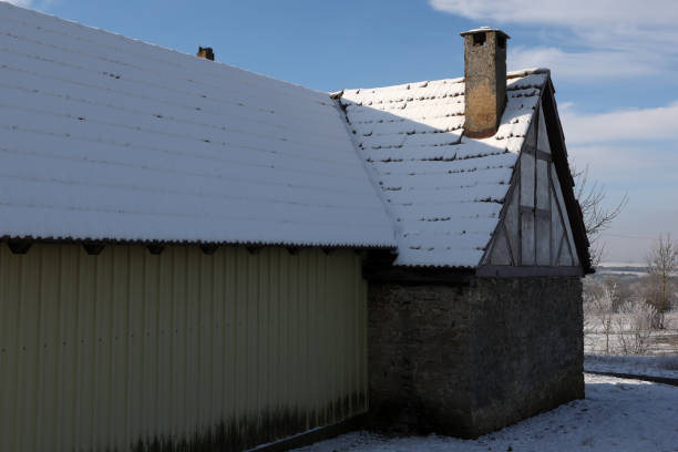 istock Old house with a chimney in winter 1296173341