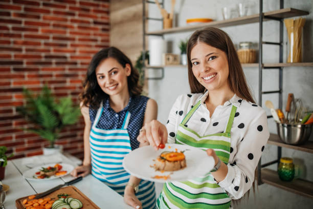 istock Young women preparing food in the kitchen 1296174047