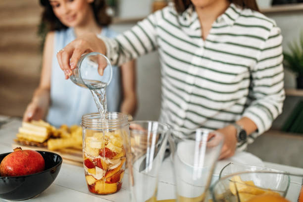 istock Young women preparing fruit salad 1296174798