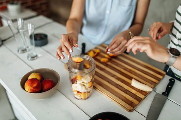 istock Young women preparing fruit salad 1296174895