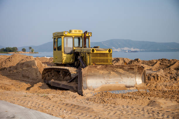 istock tractor on the beach flattens the sand 1296176416