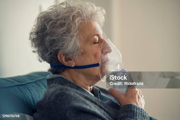 Sick Senior Woman Making Inhalation With Nebulizer Stock Photo - Download Image Now - Oxygen, Medical Oxygen Equipment, Nebulizer