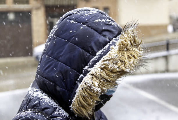 istock Hooded woman in snow 1296177901