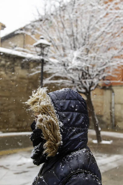 istock Hooded woman in snow 1296177907