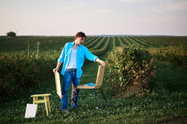 istock Artist painting on field 1296178216