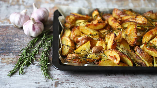 istock Delicious rustic baked potato with rosemary and garlic. 1296180000