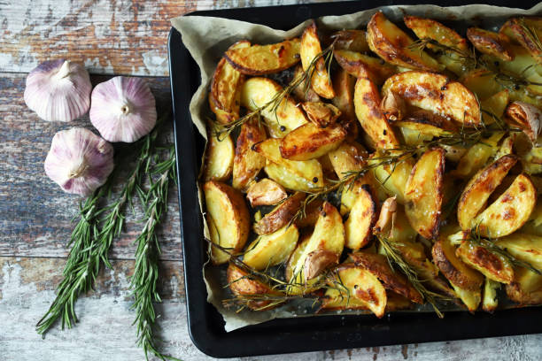 Delicious rustic baked potato with rosemary and garlic. stock photo