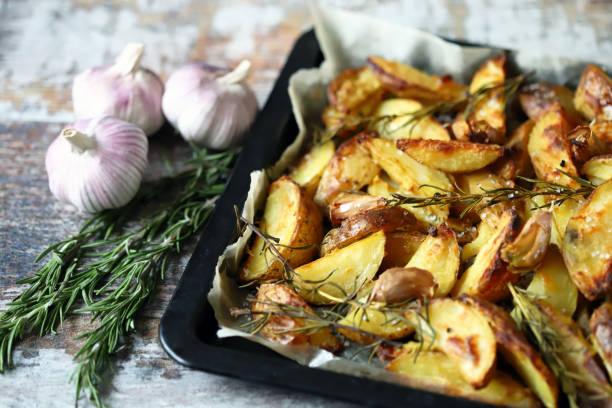 istock Baked Potato with rosemary and garlic. 1296180012